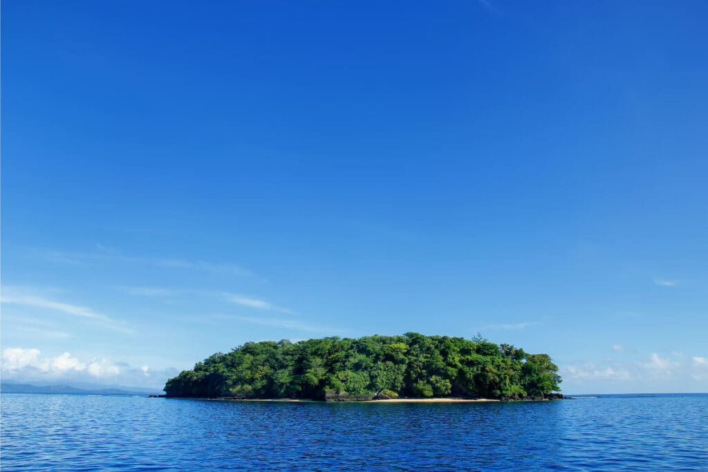 Hidden Places Around the World,
Taveuni Island surrounded by calm blue waters under a clear blue sky.